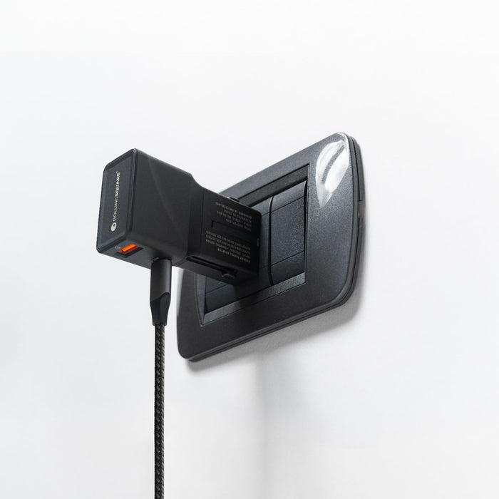 Pocket Travel Charger - US/EU/UK/AU plugs - Pocket Travel Charger - US/EU/UK/AU plugs - 30W - 1 Port - Compact black pocket travel charger plugged into a dark gray electrical outlet against a white wall. - Rolling Square Pocket Travel Charger - US/EU/UK/AU plugs - 30W - 1 Port - Compact black pocket travel charger plugged into a dark gray electrical outlet against a white wall. - Rolling Square
