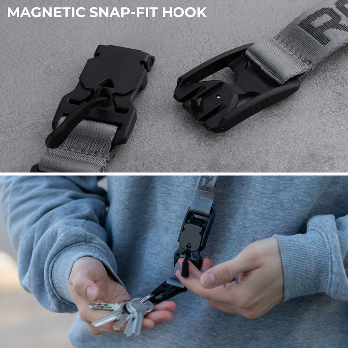 Rolling Square Lanyard - Digital ID & QR Lost Mode - Rolling Square Lanyard - Digital ID & QR Lost Mode - Silver Fog - Charcoal black lanyard with magnetic snap-fit hook holding keys, worn with gray sweatshirt. - Rolling Square Rolling Square Lanyard - Digital ID & QR Lost Mode - Silver Fog - Charcoal black lanyard with magnetic snap-fit hook holding keys, worn with gray sweatshirt. - Rolling Square