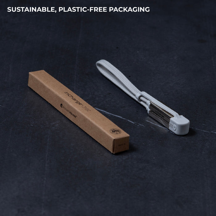 inCharge® XL 30cm / 1ft - 100W, 6in1 travel cable - inCharge® XL 30cm / 1ft - 100W, 6in1 travel cable - Urban Black - Compact white travel charging cable with integrated connectors and looped strap, next to brown eco-friendly box. - Rolling Square inCharge® XL 30cm / 1ft - 100W, 6in1 travel cable - Urban Black - Compact white travel charging cable with integrated connectors and looped strap, next to brown eco-friendly box. - Rolling Square