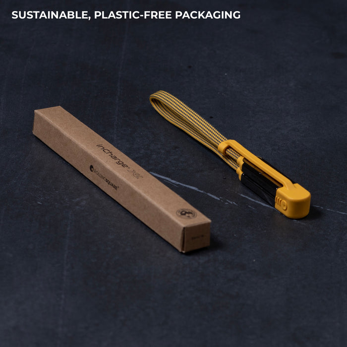 inCharge® XL 30cm / 1ft - 100W, 6in1 travel cable - inCharge® XL 30cm / 1ft - 100W, 6in1 travel cable - Urban Black - Yellow flat travel charging cable with USB-C, USB-A, Lightning, and Micro-USB connectors next to slim brown cardboard box. - Rolling Square inCharge® XL 30cm / 1ft - 100W, 6in1 travel cable - Urban Black - Yellow flat travel charging cable with USB-C, USB-A, Lightning, and Micro-USB connectors next to slim brown cardboard box. - Rolling Square