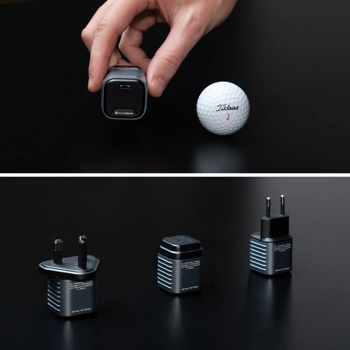 Supertiny 65W + Free 2in1 Cable (Bundle) - US - Compact black 65W USB-C charger with US, EU, and UK plug adapters and 2-in-1 charging cable beside golf ball for size. - Rolling Square