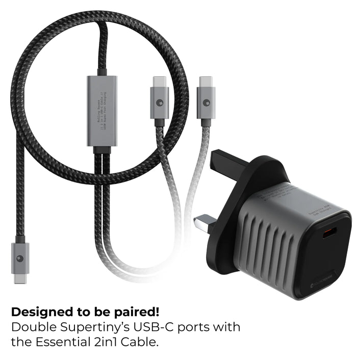Supertiny - The smallest 65W GaN Charger ever - US - Small black 65W GaN charger with UK plug next to a black and white braided 2-in-1 USB-C cable with Lightning and USB-C. - Rolling Square