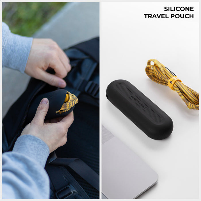 inCharge® XL 3m / 10ft - 100W, 6in1 ultra long cable - Urban Black - Black silicone travel pouch next to a coiled yellow charging cable and a laptop on white surface, hand holding pouch near. - Rolling Square