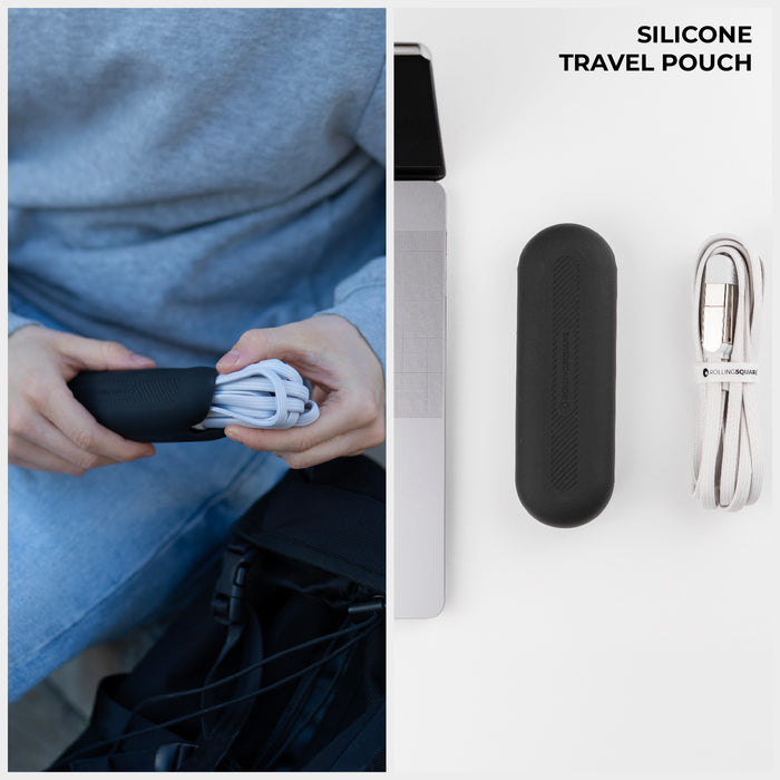 inCharge® XL 2m / 6.6ft - 100W, 6in1 super long cable - Urban Black - Black silicone travel pouch holding coiled white charging cable next to laptop and smartphone. - Rolling Square