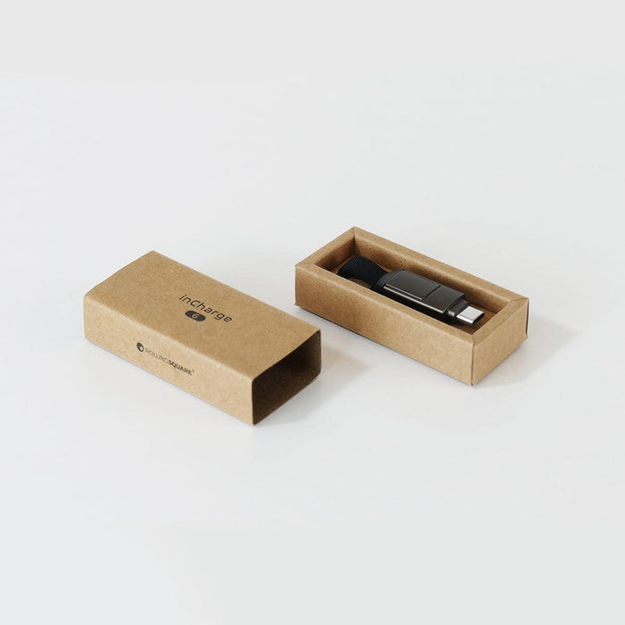 inCharge® 6 - 15W, 6in1 keyring cable - Mercury Gray - Compact black inCharge 6 multi-device charging cable with brown eco-friendly cardboard packaging on white background. - Rolling Square